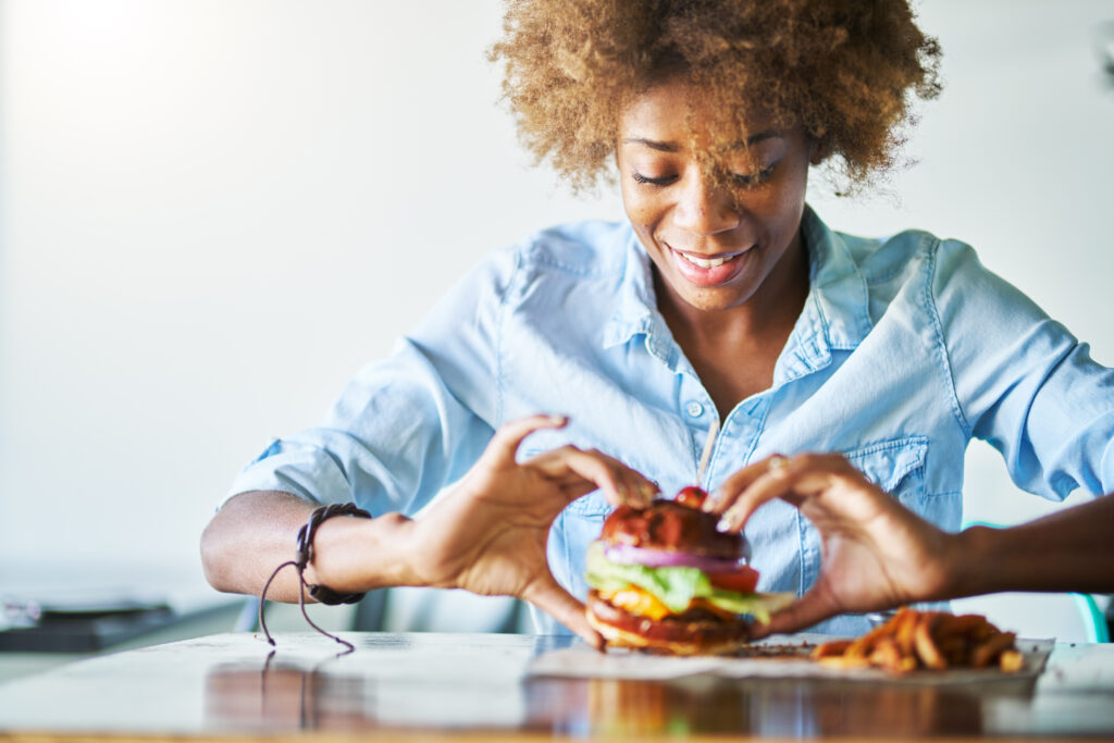 Woman eating plant-based burger