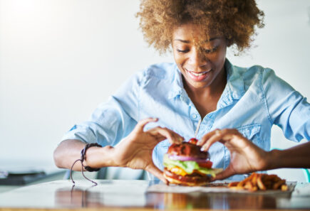 Woman eating plant-based burger