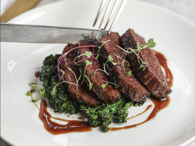 Plant-based steak with broccoli and a glaze