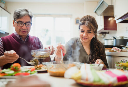Couple heating a healthy home cooked meal