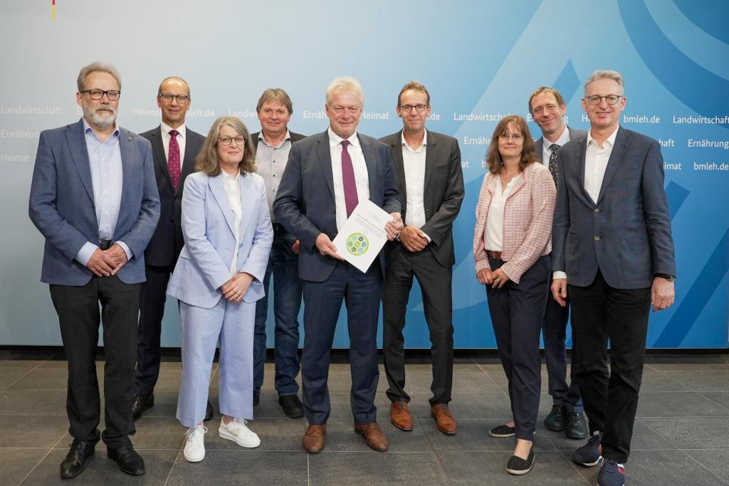 Photo from the launch of the BMLEH report, with people from the launch holding a copy of the report on protein diversification