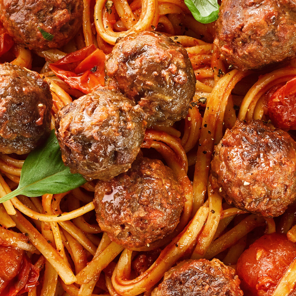 A picture of plant-based meatballs and spaghetti. 